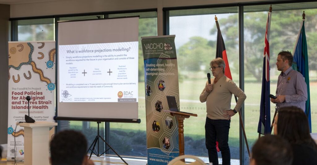 Jim O’Shea (left) and Dallas Widdicombe, CEO of Bendigo & District Aboriginal Co-operative, presenting the model at a VACCHO Member meeting.